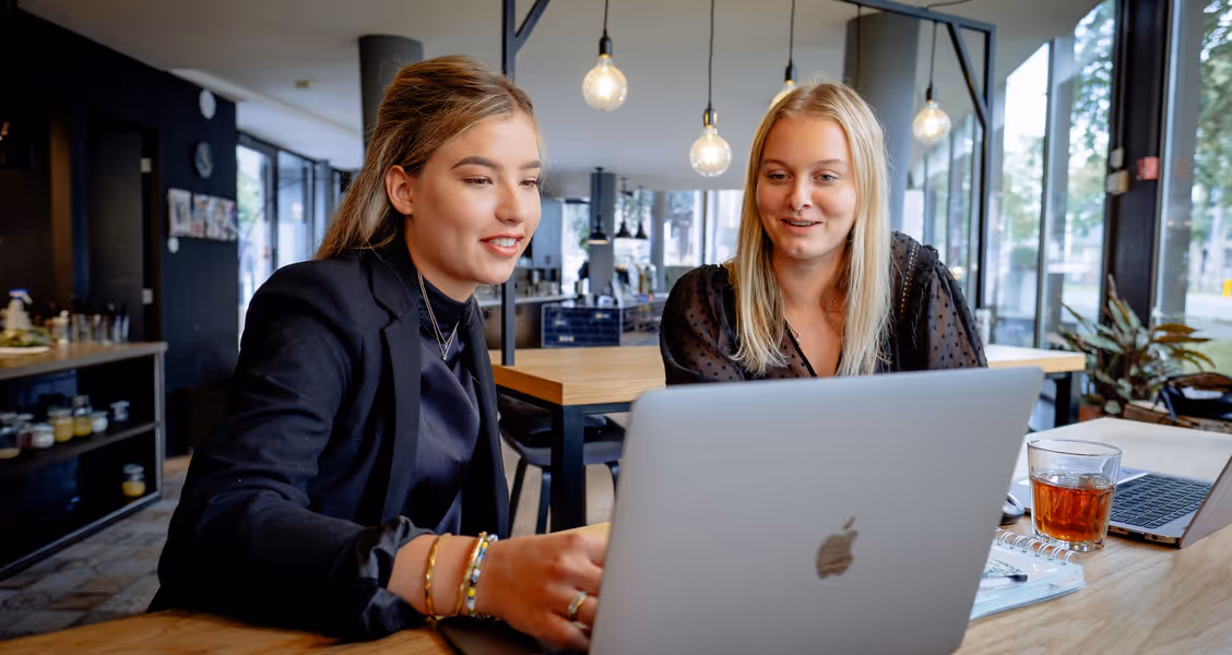 Two girls in front of a computer