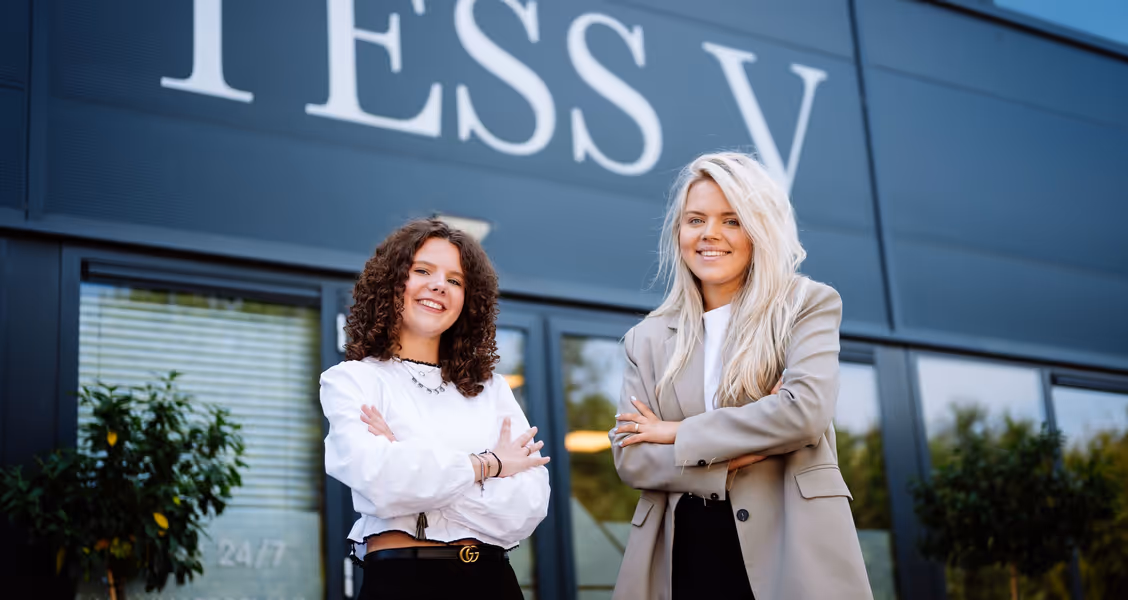 Two women in front of a building posing